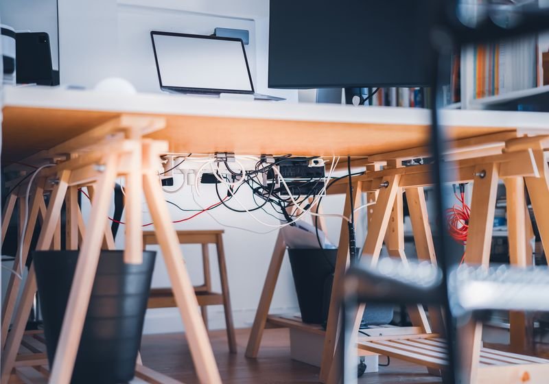 Cables and wires organised under a desk