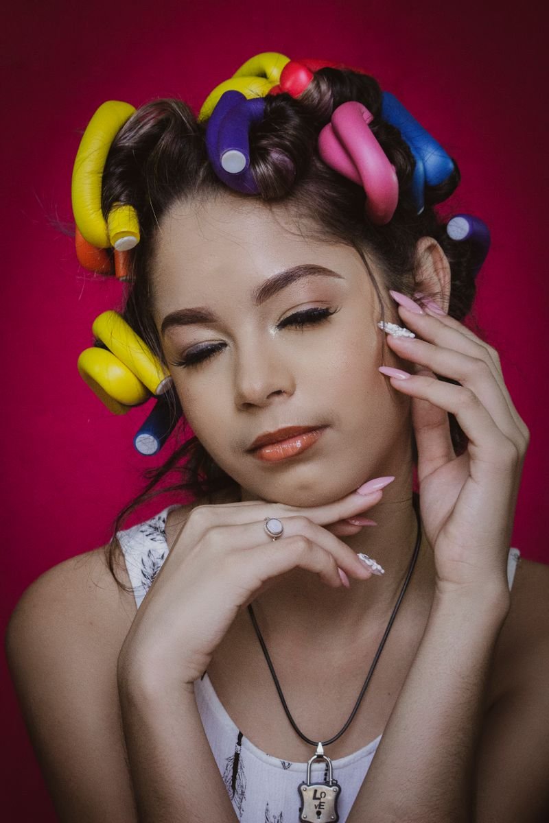 Woman with colourful heatless flexi-rod curlers in her hair